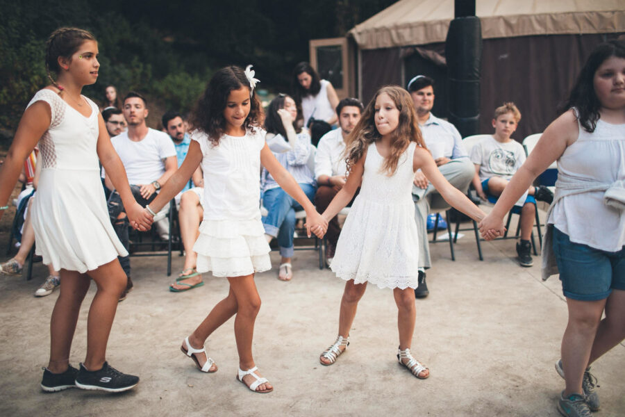 girls dancing hand in hand in a circle.