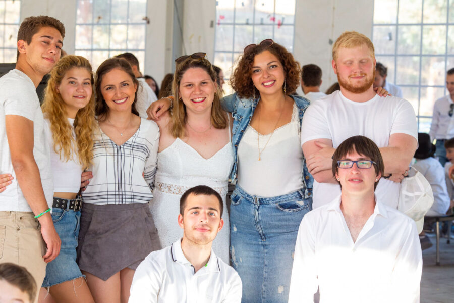 group of teens wearing white shirts.