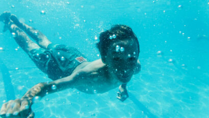 boy swimming underwater.