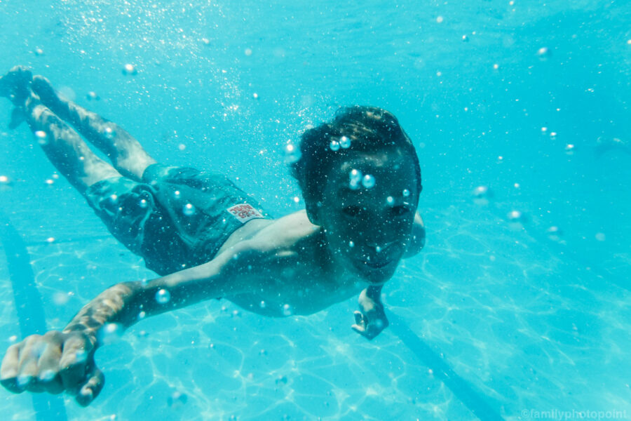 boy swimming underwater.