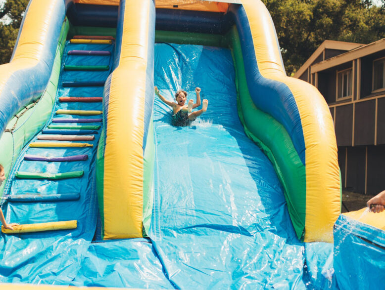 kid sliding down a water slide.